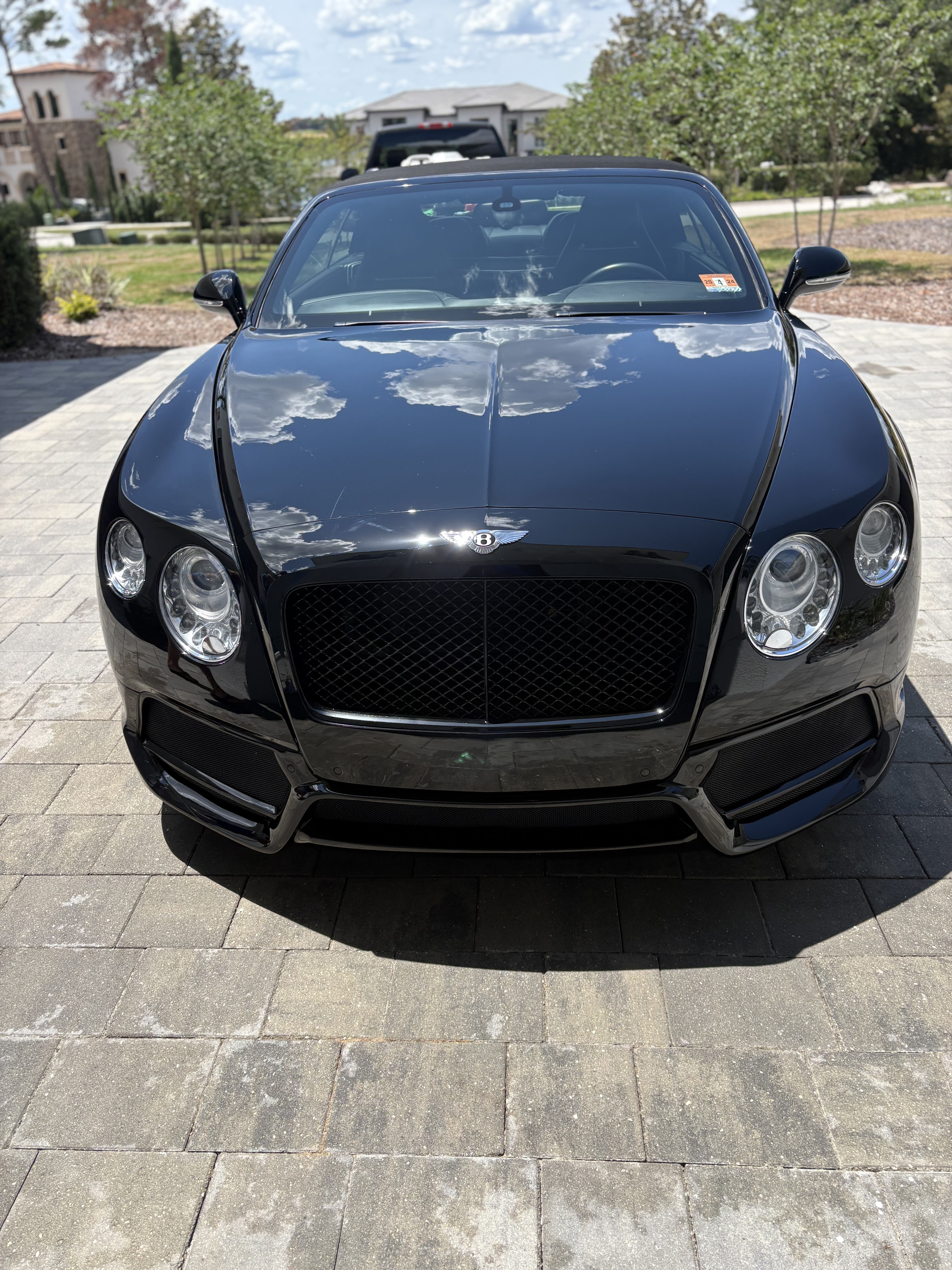 Black Bentley Continental GTC convertible detailed to a deep gloss