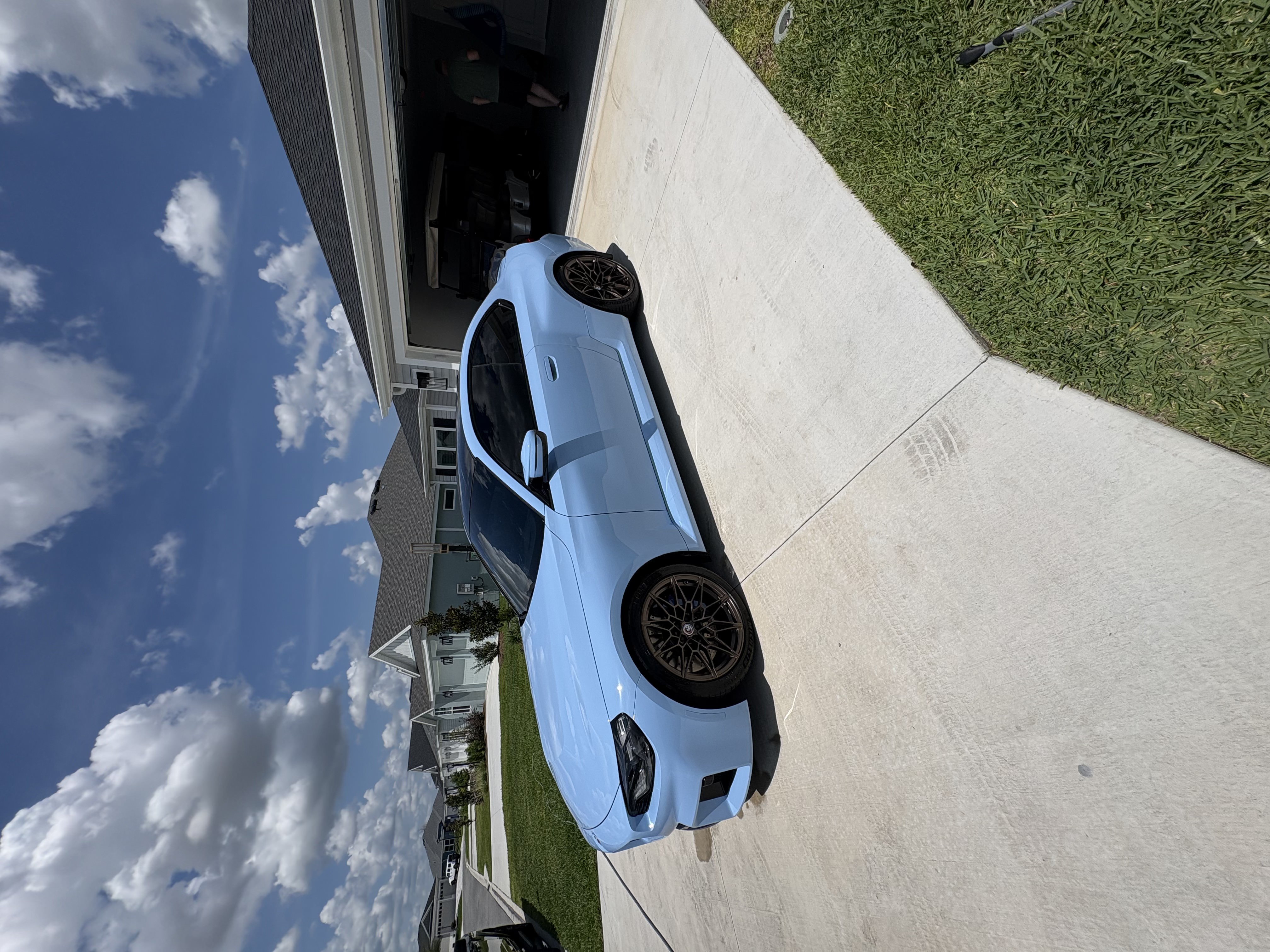 Baby blue BMW M2 with a flawless gloss finish after mobile detailing in a Lake County, FL driveway
