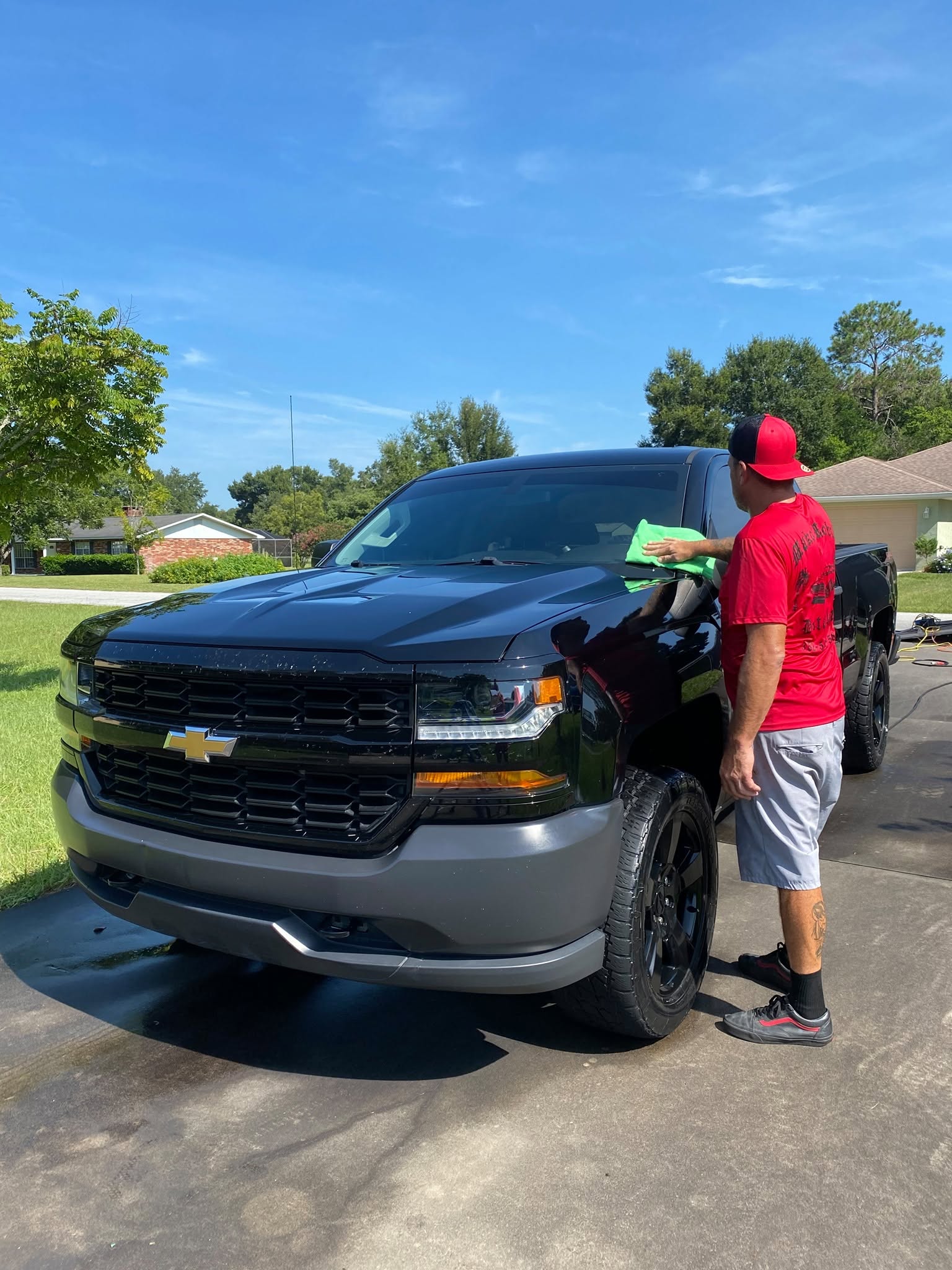 Mako technician hand-finishing a black Chevy Silverado in Tavares, FL