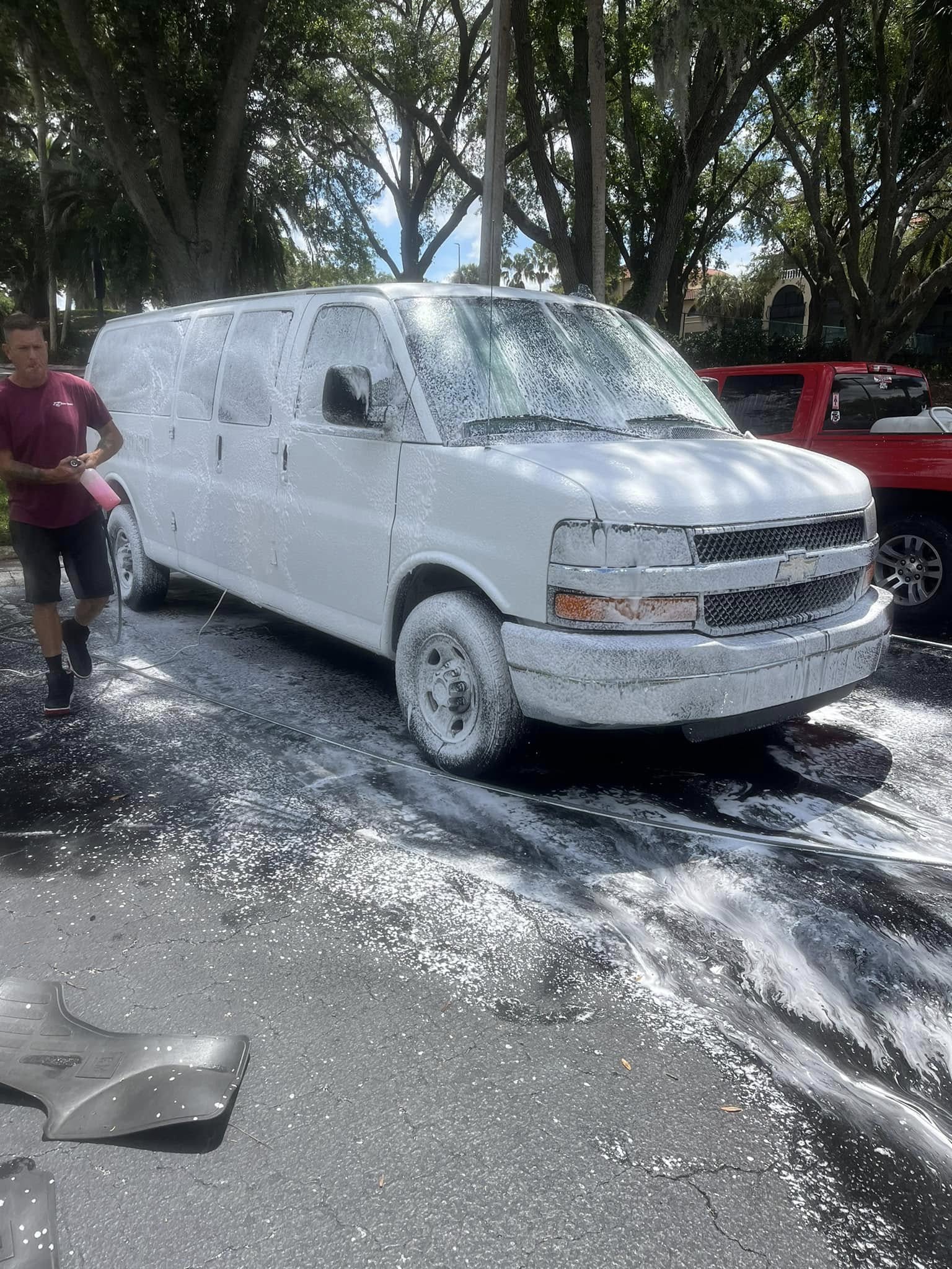 White Chevy van covered in foam during fleet washing