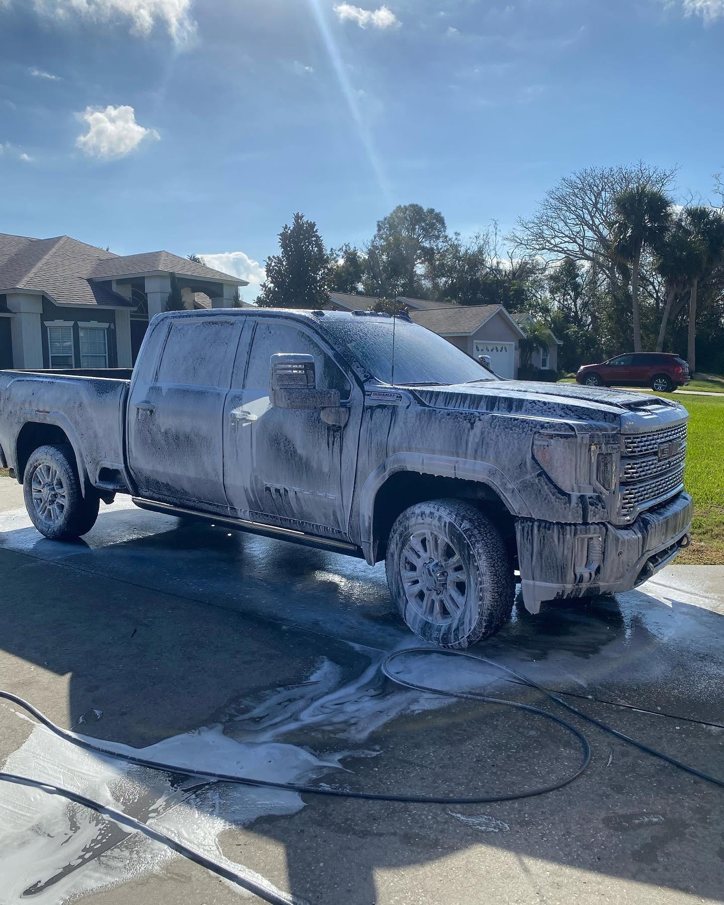 GMC truck covered in thick foam during a mobile exterior wash in Lake County, FL