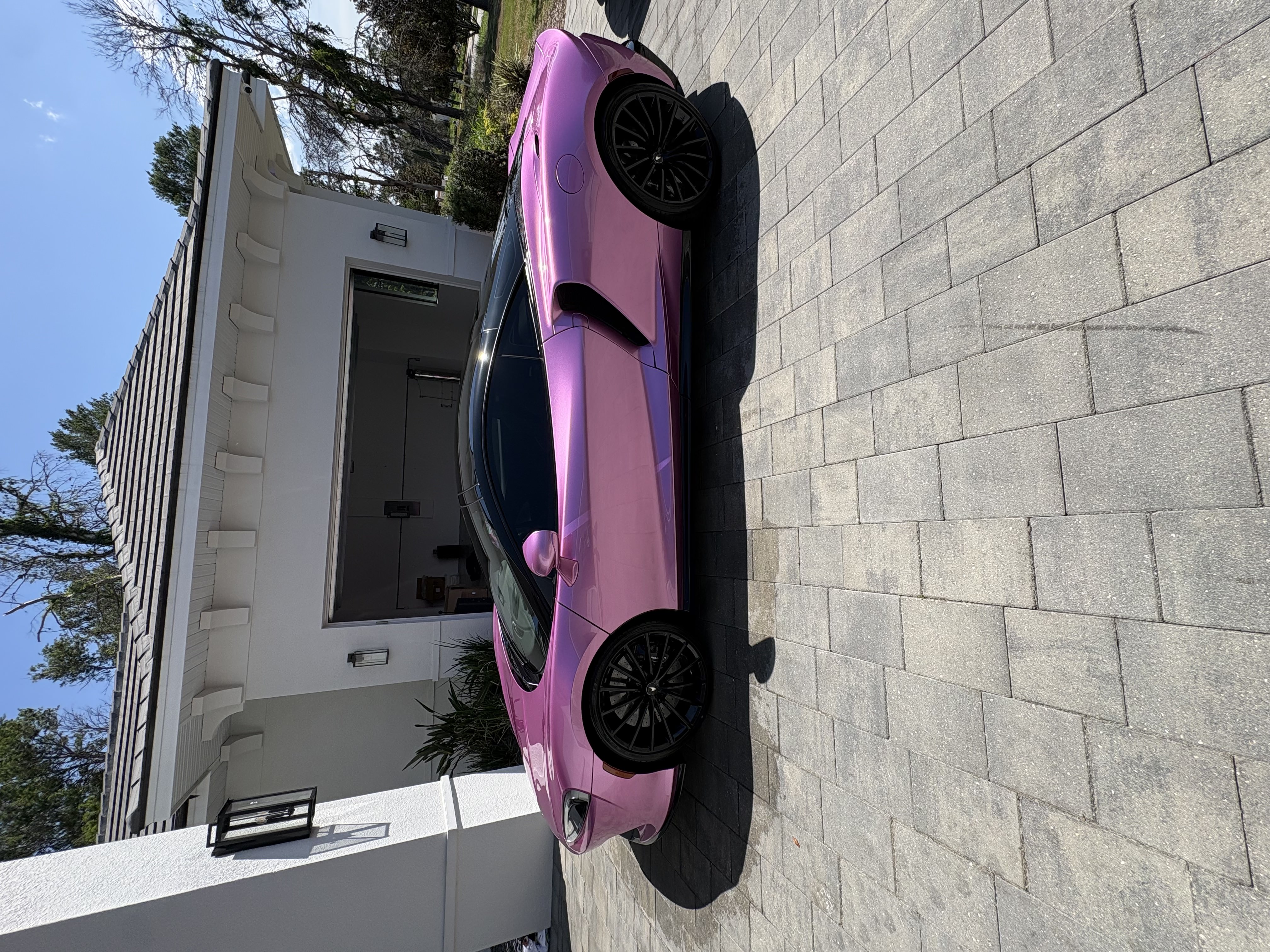 Custom pink McLaren GT with a mirror finish after mobile detailing