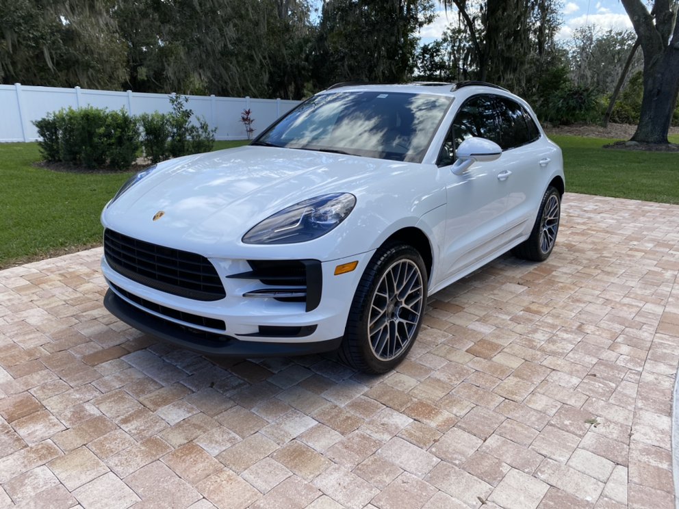 White Porsche Macan detailed in a Clermont, FL driveway by Mako Mobile Detailing